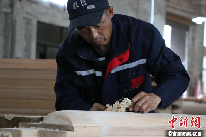 一位木工在给古建筑木构件抛光刘浩摄